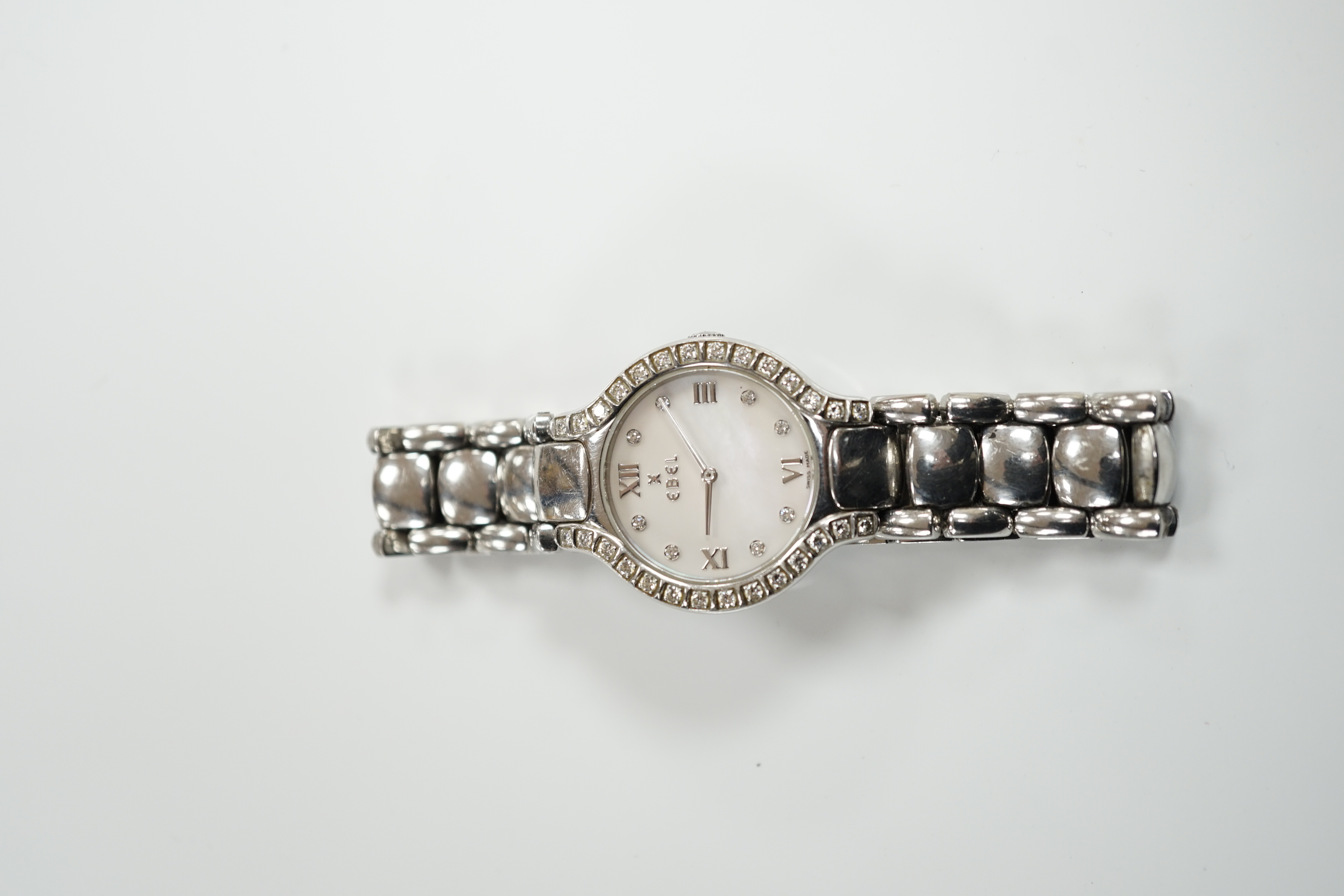 A lady's 2001 stainless steel Ebel quartz wrist watch, with diamond set bezel, mother of pearl dial and diamond dot markers, on a stainless steel bracelet, with box and guarantee.